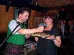 Stuart ritually stabs the haggis being held by Rose McEwan